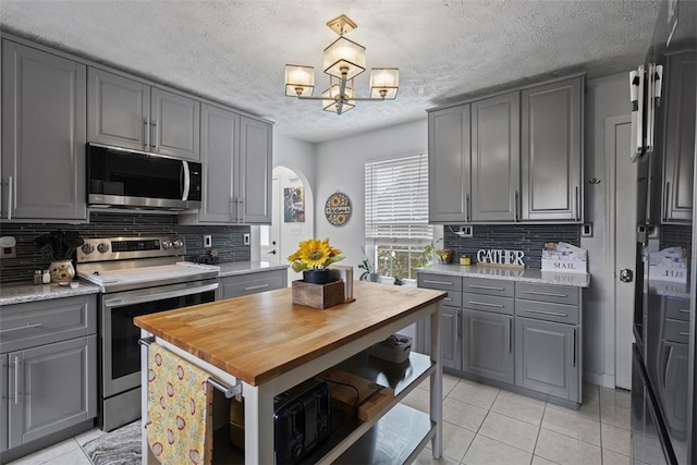 23 Sunset Ct, Cranberry Twp, PA 16066 - kitchen featuring stainless steel appliances, gray cabinets, wood counters, a textured ceiling, and light tile patterned floors