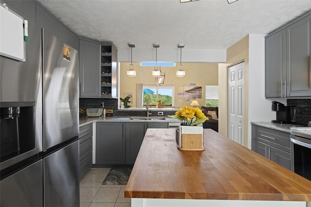 23 Sunset Ct, Cranberry Twp, PA 16066 - kitchen with appliances with stainless steel finishes, gray cabinets, wood counters, decorative backsplash, and a textured ceiling