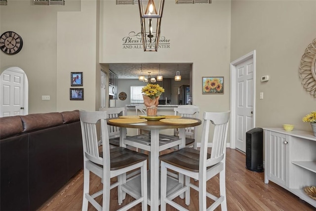 23 Sunset Ct, Cranberry Twp, PA 16066 - dining space featuring a high ceiling, wood finished floors, and a chandelier