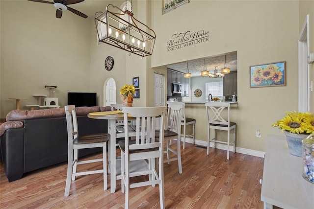 23 Sunset Ct, Cranberry Twp, PA 16066 - dining room with a ceiling fan, wood finished floors, and a towering ceiling