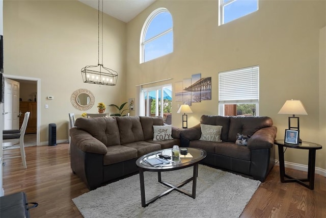 23 Sunset Ct, Cranberry Twp, PA 16066 - living area featuring a high ceiling, a chandelier, and wood finished floors