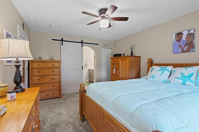 23 Sunset Ct, Cranberry Twp, PA 16066 - bedroom with light carpet, a barn door, a ceiling fan, and ensuite bathroom