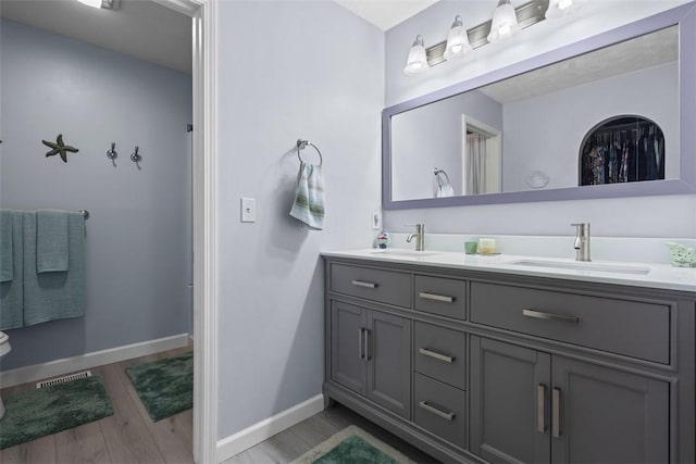 23 Sunset Ct, Cranberry Twp, PA 16066 - bathroom featuring double vanity and wood finished floors