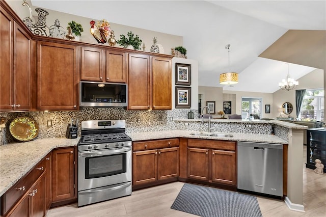 1041 Clerkenwell Ln, Cranberry Twp, PA 16066 - kitchen with appliances with stainless steel finishes, a peninsula, lofted ceiling, backsplash, and a chandelier