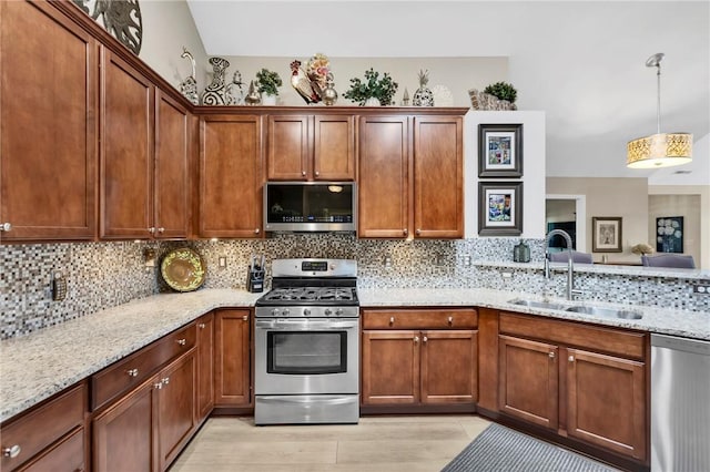 1041 Clerkenwell Ln, Cranberry Twp, PA 16066 - kitchen featuring appliances with stainless steel finishes, tasteful backsplash, light stone countertops, and decorative light fixtures