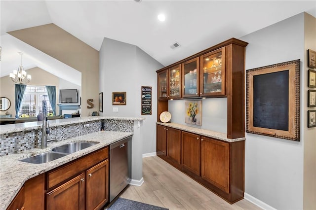 1041 Clerkenwell Ln, Cranberry Twp, PA 16066 - kitchen with stainless steel dishwasher, lofted ceiling, a chandelier, light stone countertops, and light wood-type flooring