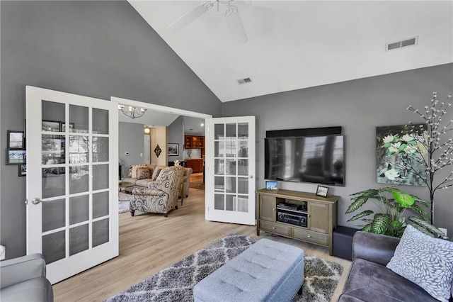 1041 Clerkenwell Ln, Cranberry Twp, PA 16066 - living room with high vaulted ceiling, wood finished floors, a chandelier, a ceiling fan, and french doors