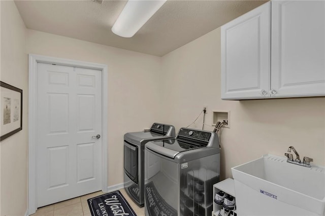 1041 Clerkenwell Ln, Cranberry Twp, PA 16066 - washroom with separate washer and dryer, cabinet space, and light tile patterned floors