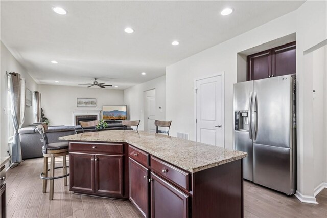 2811 De Paul Ct, Franklin Park, PA 15143 - kitchen featuring stainless steel fridge with ice dispenser, ceiling fan, light wood-type flooring, a fireplace, and open floor plan