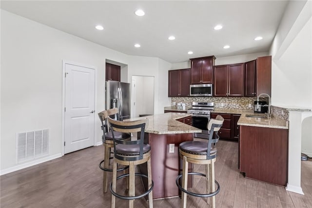 2811 De Paul Ct, Franklin Park, PA 15143 - kitchen with stainless steel appliances, wood finished floors, a center island, tasteful backsplash, and recessed lighting