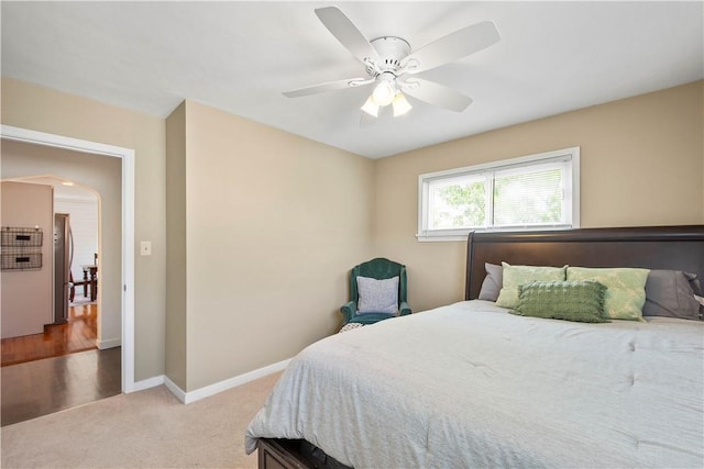 108 Mary St, Ross Twp, PA 15214 - bedroom featuring freestanding refrigerator, light colored carpet, ceiling fan, and arched walkways