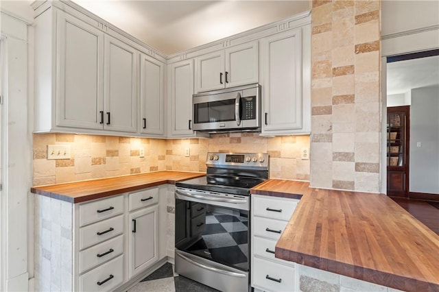2026 Darlington Rd, Chippewa Twp, PA 15010 - kitchen featuring wooden counters, appliances with stainless steel finishes, a peninsula, and tasteful backsplash