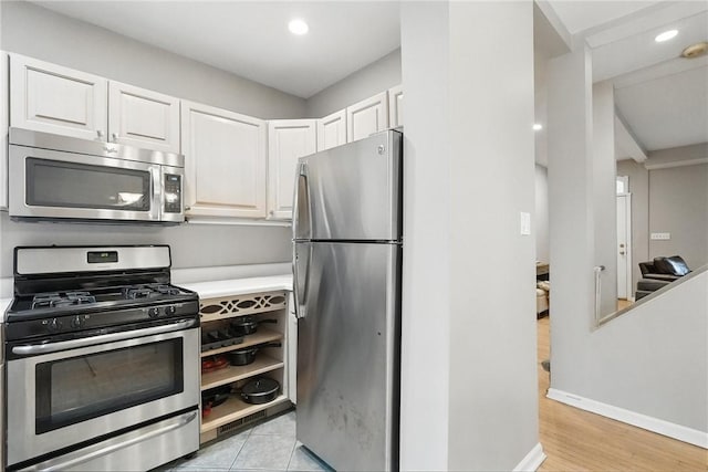 5727 Kentucky Ave, Shadyside, PA 15232 - kitchen featuring stainless steel appliances, white cabinets, recessed lighting, light countertops, and light wood-style floors
