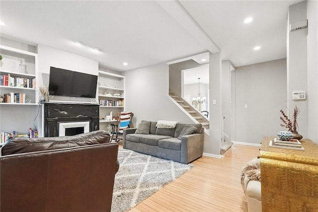 5727 Kentucky Ave, Shadyside, PA 15232 - living room with stairs, light wood-style floors, a fireplace, recessed lighting, and a chandelier