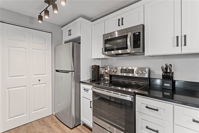 6013 Patrick Henry, Hopewell Twp Bea, PA 15001 - kitchen with appliances with stainless steel finishes, dark countertops, light wood-style flooring, and white cabinetry