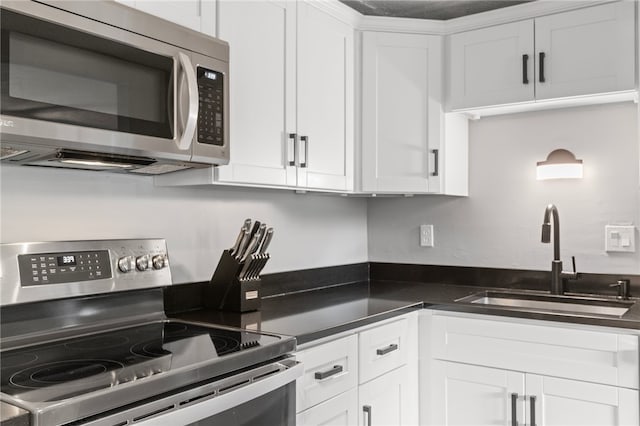 6013 Patrick Henry, Hopewell Twp Bea, PA 15001 - kitchen with appliances with stainless steel finishes, white cabinetry, and dark countertops