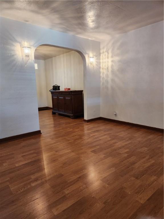 820 Shawnee, Schenley Heights, PA 15219 - spare room with arched walkways and dark wood-style flooring