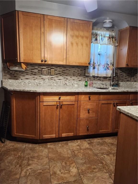 820 Shawnee, Schenley Heights, PA 15219 - kitchen featuring backsplash, brown cabinetry, and light stone countertops