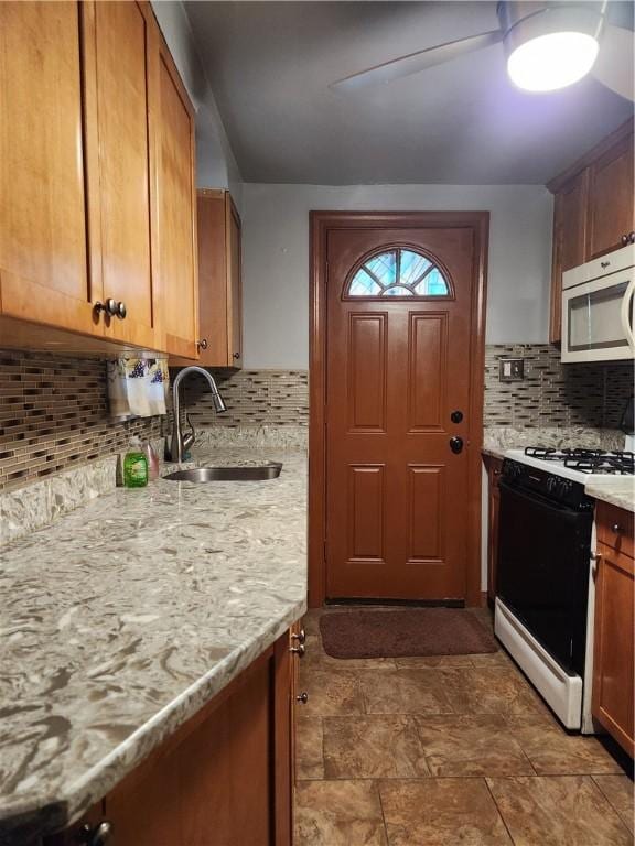 820 Shawnee, Schenley Heights, PA 15219 - kitchen with stainless steel microwave, gas range oven, decorative backsplash, and brown cabinets