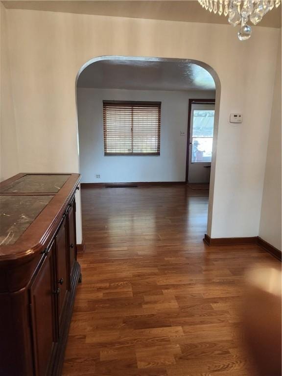 820 Shawnee, Schenley Heights, PA 15219 - hallway with arched walkways, wood finished floors, and a chandelier