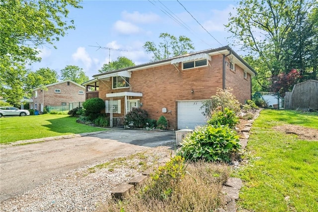 11 Frick Ave, Irwin, PA 15642 - view of front facade with dirt driveway, an attached garage, and brick siding