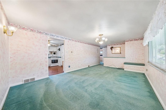 11 Frick Ave, Irwin, PA 15642 - unfurnished room with wallpapered walls, a chandelier, carpet flooring, and a ceiling fan
