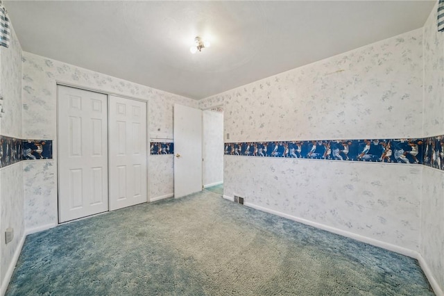 11 Frick Ave, Irwin, PA 15642 - unfurnished bedroom featuring wallpapered walls, carpet, and a closet