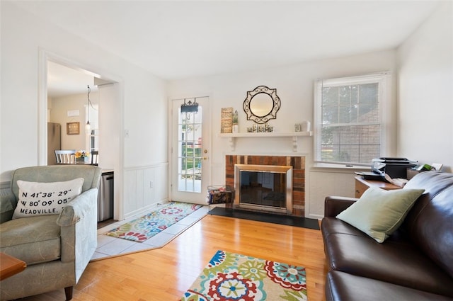 202 Roscommon Pl, Peters Twp, PA 15317 - living room featuring wood finished floors, a brick fireplace, and wainscoting