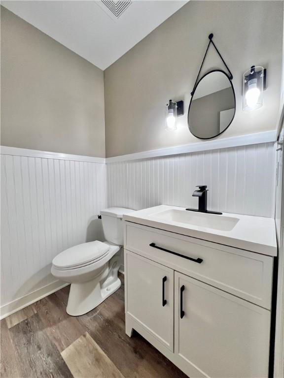 202 Roscommon Pl, Peters Twp, PA 15317 - bathroom featuring vanity, wainscoting, and wood finished floors