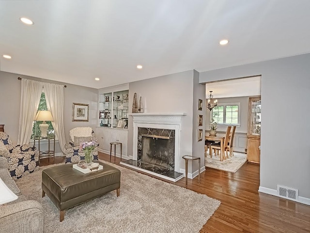776 Elm Spring Rd, Mt Lebanon, PA 15243 - living room featuring wood finished floors, recessed lighting, a fireplace, and a chandelier