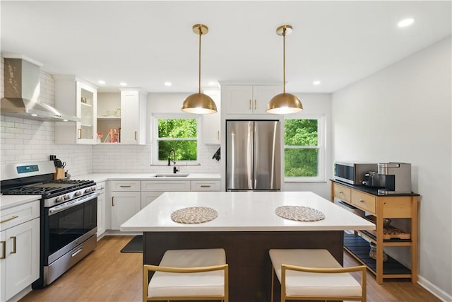 110 Simon Ave, Ross Twp, PA 15237 - kitchen featuring stainless steel appliances, wall chimney exhaust hood, plenty of natural light, light wood finished floors, and recessed lighting
