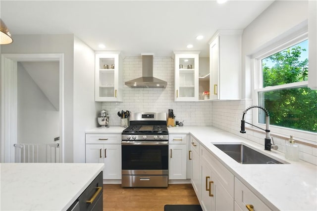 110 Simon Ave, Ross Twp, PA 15237 - kitchen with wall chimney exhaust hood, stainless steel range with gas stovetop, backsplash, white cabinetry, and recessed lighting