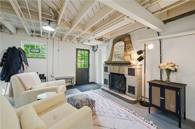 110 Simon Ave, Ross Twp, PA 15237 - living room with concrete block wall, healthy amount of natural light, a stone fireplace, and concrete flooring