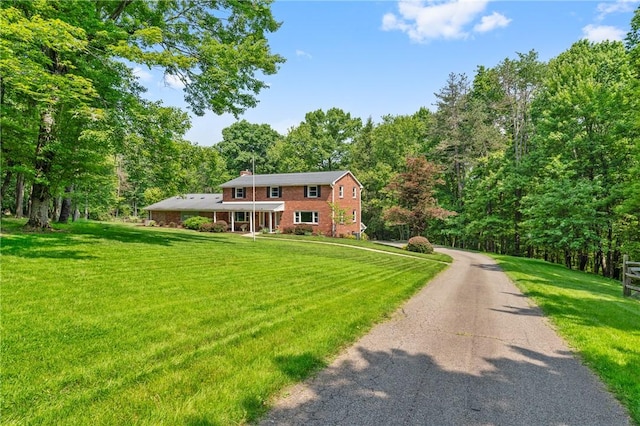 4077 Clarkland Ave, Hampton, PA 15101 - colonial-style house with a front lawn, a view of trees, and driveway