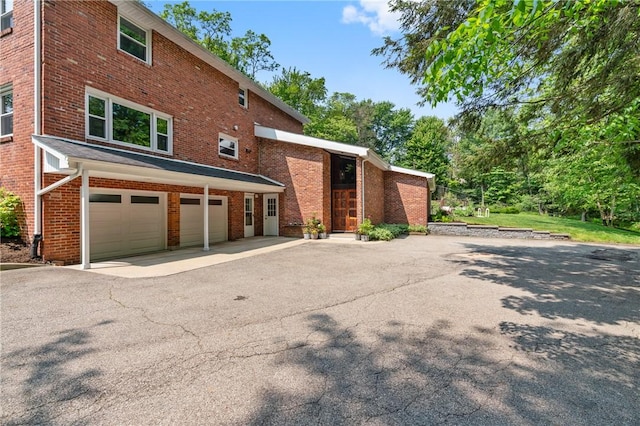 4077 Clarkland Ave, Hampton, PA 15101 - view of front of property featuring brick siding, a garage, and asphalt driveway