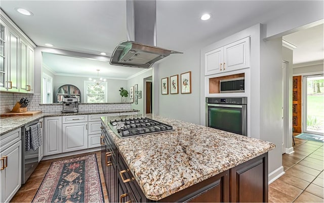 4077 Clarkland Ave, Hampton, PA 15101 - kitchen with stainless steel appliances, island exhaust hood, a center island, decorative backsplash, and a chandelier