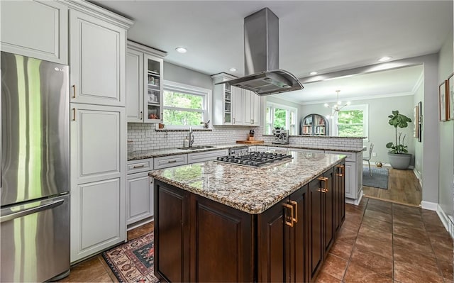 4077 Clarkland Ave, Hampton, PA 15101 - kitchen with appliances with stainless steel finishes, island range hood, a peninsula, decorative backsplash, and plenty of natural light
