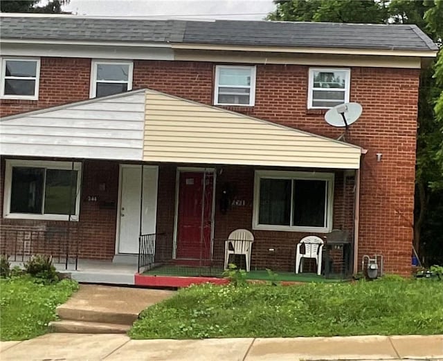 242 Chester Ave, Perry Hilltop, PA 15214 - multi unit property with brick siding, covered porch, and a shingled roof