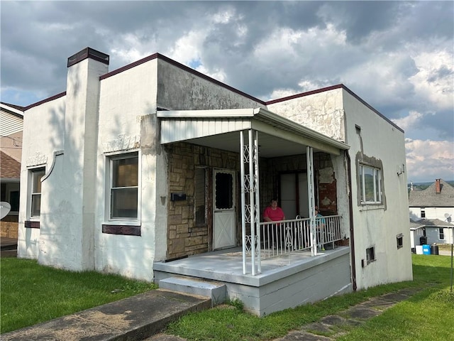 147 S 9th St, Connellsville, PA 15425 - back of house featuring a porch, a chimney, and stone siding