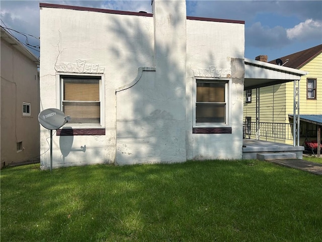 147 S 9th St, Connellsville, PA 15425 - view of property exterior featuring a yard and stucco siding
