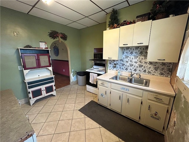 147 S 9th St, Connellsville, PA 15425 - kitchen with white electric stove, a paneled ceiling, black microwave, light countertops, and light tile patterned floors