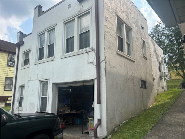 147 S 9th St, Connellsville, PA 15425 - view of side of property featuring stucco siding and a garage