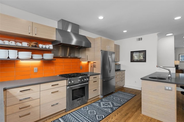 5508 Darlington Rd, Squirrel Hill, PA 15217 - kitchen with stainless steel appliances, wall chimney range hood, dark countertops, light brown cabinets, and dark wood-style floors