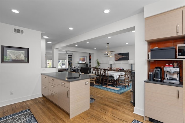 5508 Darlington Rd, Squirrel Hill, PA 15217 - kitchen featuring a peninsula, wood finished floors, dark countertops, open floor plan, and modern cabinets