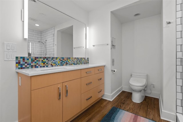 5508 Darlington Rd, Squirrel Hill, PA 15217 - full bathroom featuring vanity, wood finished floors, decorative backsplash, and a tile shower