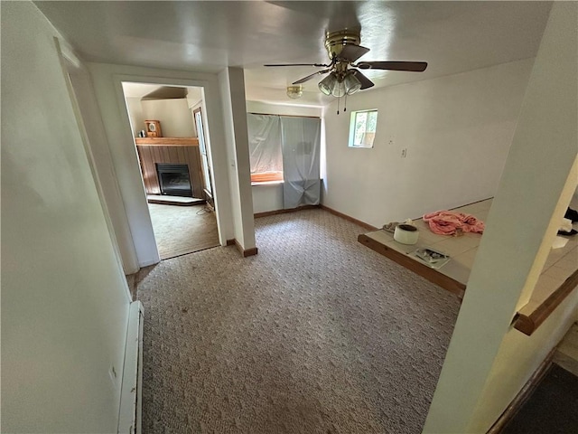 19 Wickhaven Hollow Rd, Perry Twp Fay, PA 15492 - carpeted spare room with a fireplace with raised hearth, ceiling fan, and a baseboard heating unit
