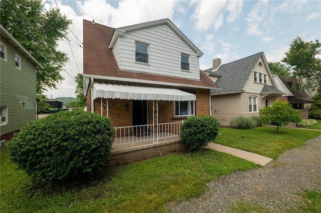 347 Washington St, Leetsdale, PA 15056 - view of front of property with brick siding, a front lawn, a porch, and a shingled roof