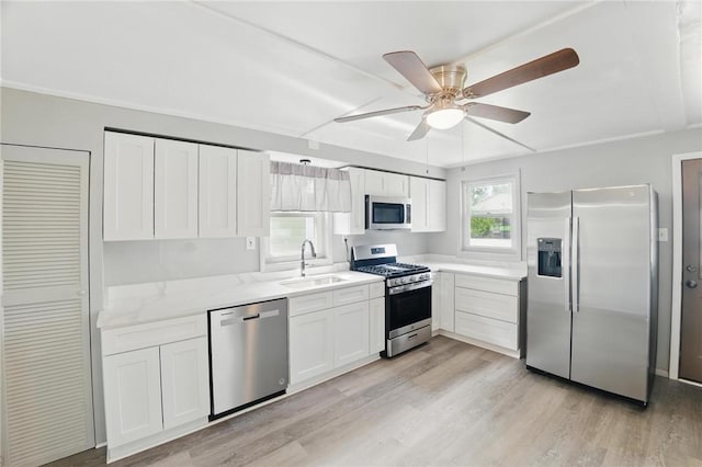 347 Washington St, Leetsdale, PA 15056 - kitchen featuring appliances with stainless steel finishes, light wood-style floors, ceiling fan, and white cabinets