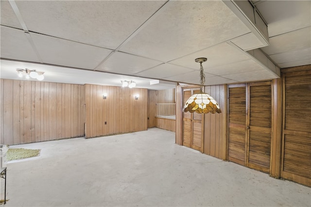 480 Herbst Manor Rd, Kennedy Twp, PA 15108 - unfurnished dining area with unfinished concrete flooring and wooden walls