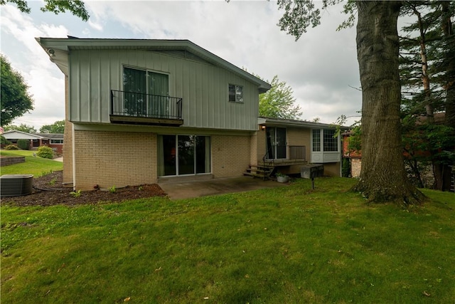 480 Herbst Manor Rd, Kennedy Twp, PA 15108 - rear view of house featuring brick siding, a balcony, a yard, a patio area, and board and batten siding